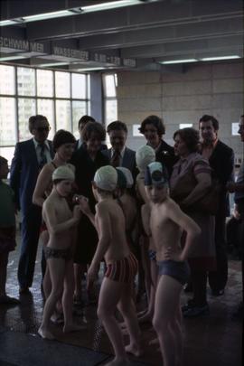 Iona Campagnolo standing with unknown adults and young swimmers at an aquatic centre in East Germany