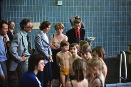 Iona Campagnolo with a group of unknown adults and children at a swimming pool in East Germany