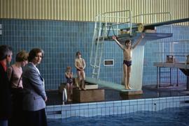Iona Campagnolo with a two unknown adults and children on a diving board in East Germany