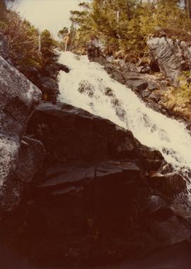 Men and waterfall by Klemtu Lake