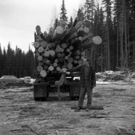 Pulpwood Logging Operations on P.T.S. X91960, Swamp Lake, Prince George Pulp and Paper Ltd. showing man by pre-loading logging trailer