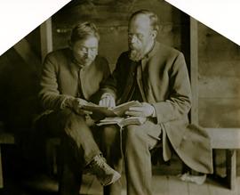Archdeacon W.H. Collison giving reading lesson to unidentified man at Kincolith, BC