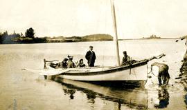 Bertha and W.E. Collison in boat with young daughters, leaving Metlakatla, BC for England