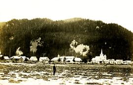 Archdeacon W.H. Collison standing on beach at Kincolith, BC