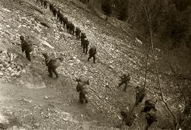 Soldiers traversing switchbacks on rocky slope