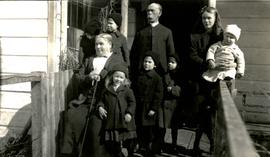 Marion and W.H. Collison posing with grandchildren on porch at Kincolith, BC