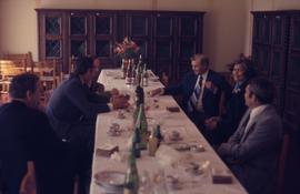 Iona Campagnolo with five men at a table in Germany