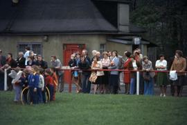 Iona Campagnolo with a crowd of adult spectators watching children in East Germany