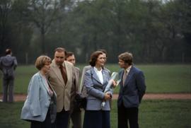 Iona Campagnolo holding flowers and standing with unknown people in East Germany