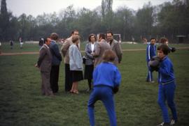 Iona Campagnolo with unknown people in a sports field in East Germany