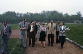 Iona Campagnolo holding flowers while walking with a group in East Germany