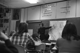 Iona Campagnolo pointing at a map of BC and talking to Haida Gwaii students
