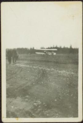 Men and Plane in Field