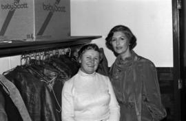 Iona Campagnolo poses with unidentified woman in coatroom