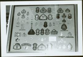 Framed collection of badges from the Royal Canadian Naval Air Service and Naval Fire Service