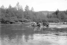 Iona Campagnolo paddles raft with unidentified men during Kitimat Delta King Days raft race