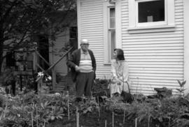 Iona Campagnolo talks with unidentified man in home garden