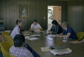 Iona Campagnolo and men in meeting room at fish cannery