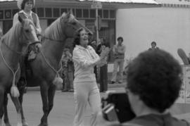 Iona Campagnolo walking in parade in Smithers in front of horses