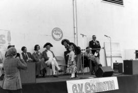 Deputy Premier Grace McCarthy and young girl on stage with Iona Campagnolo and others in backgrou...