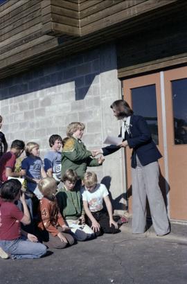 Iona Campagnolo presenting a certificate to a participant in the Terrace Minor Hockey school