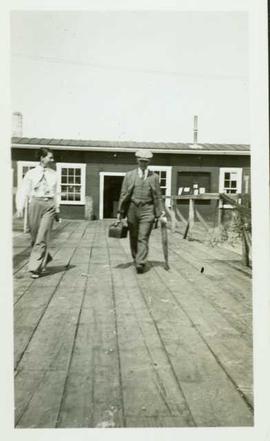 Dr. Armstrong and Nurse Hall leaving a fish cannery