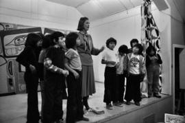 Iona Campagnolo on stage with Glen Vowell First Nations children at potluck following key presentation