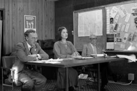 Iona Campagnolo at a table with Vic Walton and John Blake during meeting with disaster officials in Terrace