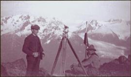 Taku River Survey - Two Men at Flag with Camera