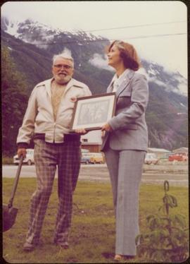 Iona Campagnolo presents framed archival photograph to Waidlow Stewart at the Stewart Museum