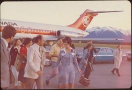 Iona Campagnolo leading Pierre Trudeau from his plane, June 1974