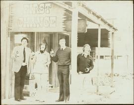 John Hanquest, Iona Campagnolo, and two unidentified men raise bottles of beer outside the First Chance Saloon in Stewart, BC
