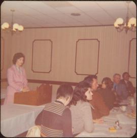 M.P. Iona Campagnolo speaking at a podium in a conference room, Terrace, BC