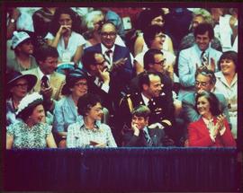 Queen Elizabeth, unidentified woman, Prince Edward, and Minister Iona Campagnolo, seated at 1976 Summer Olympic Games, crowd in background, Montreal, QC
