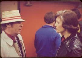 Iona Campagnolo speaking to an unidentified man wearing a bucket hat