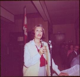 Iona Campagnolo speaking into a microphone at Chetwynd, BC