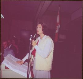 Iona Campagnolo speaking into a microphone at podium in Chetwynd, BC