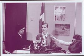 Announcing Green Paper on recreation - Two unidentified journalists hold microphones as Iona Camp...