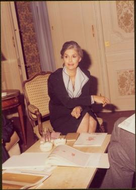 Paris Press Conference - Iona Campagnolo talking from chair at coffee table covered with documents