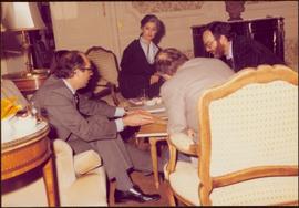 Paris Press Conference - Iona Campagnolo looks on while Roger Jackson speaks to two unidentified men seated at coffee table