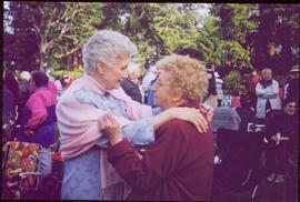 Iona Campagnolo embracing a woman named Hlia at a garden function in Victoria, BC