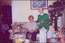 Iona Campagnolo sits beside a woman named Hlia on couch in unknown room, Victoria, BC