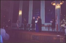 Lieutenant Governor Iona Campagnolo and unidentified man present an award to unidentified woman o...
