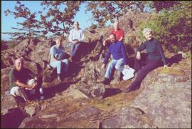 Five gardeners and Iona Campagnolo sitting on rocky outcrop in Terrace Gardens, Government House,...