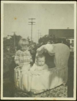 Two Young Children & Bassinet
