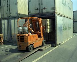 Loading asbestos into shipping containers using forklift