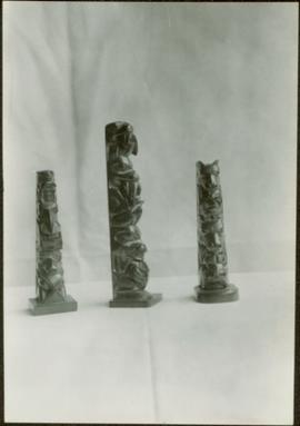 Three argillite totem poles