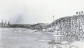 Collapsed railroad bridge with damaged pilings