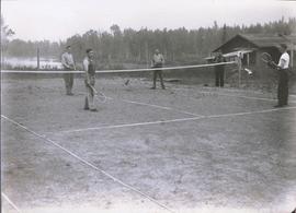 Four men playing tennis