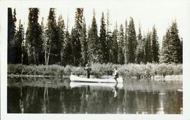 Two men fishing from a canoe